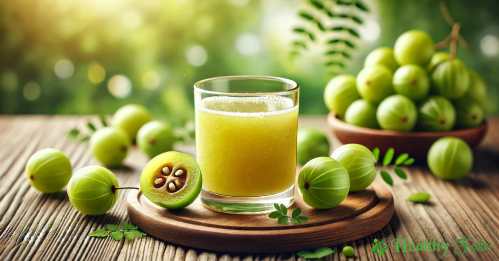 A glass of fresh Amla juice with Indian gooseberries on a wooden table.